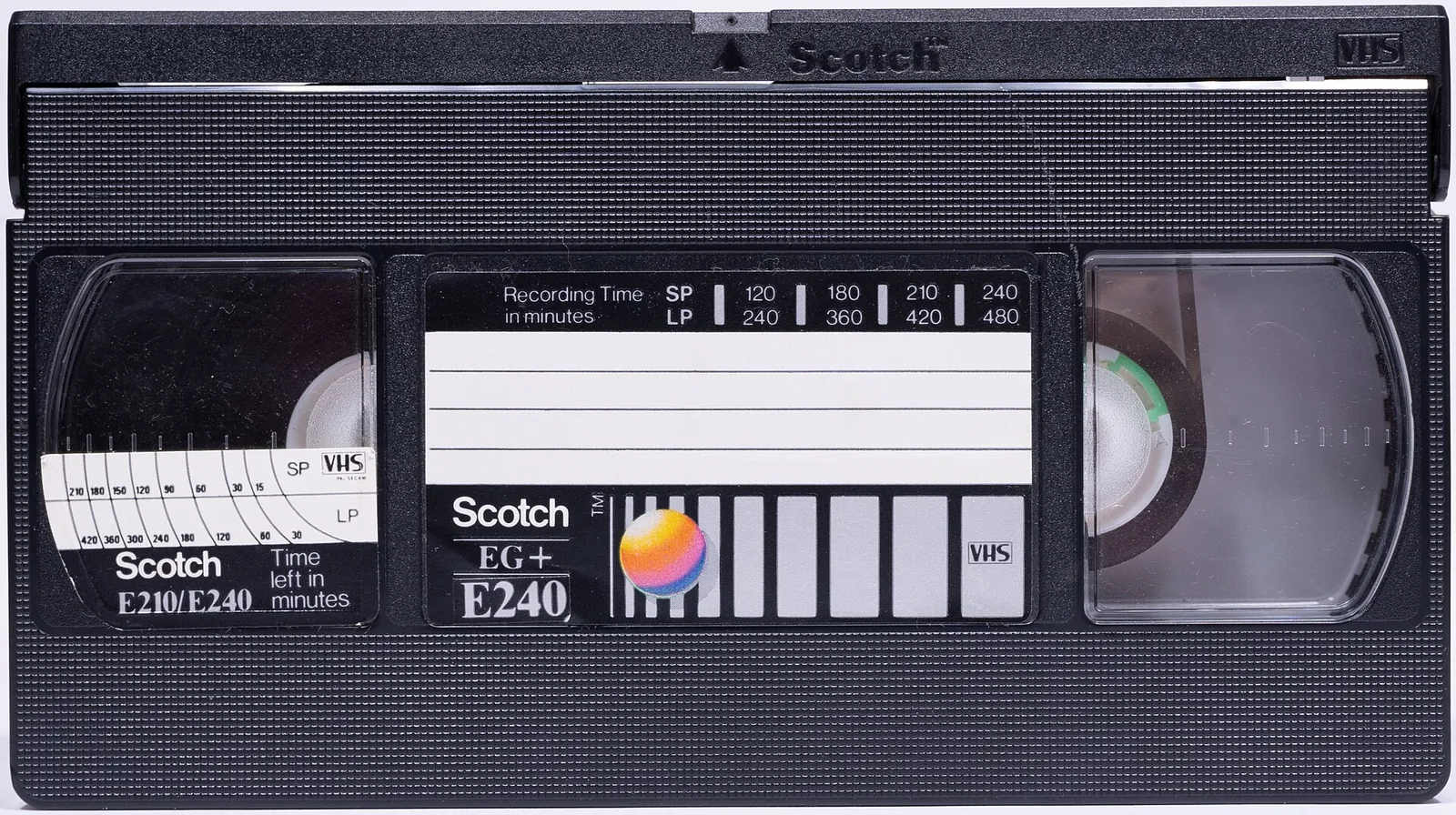 A VHS cassette with a blank label and a recording time scale